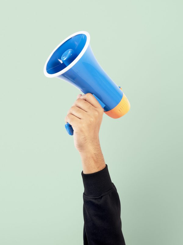 Hand holding megaphone marketing announcement campaign